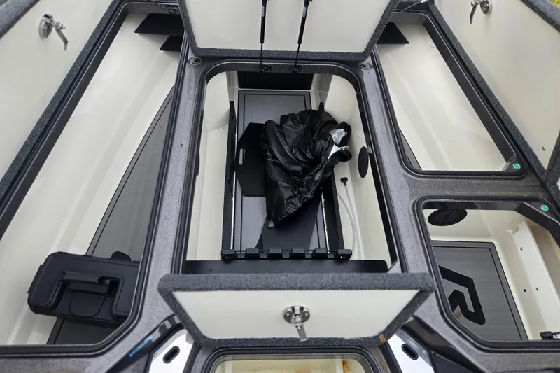 Slide: The Image of 2023 Ranger Z521R boat storage compartments with open lids and interior view. - 13