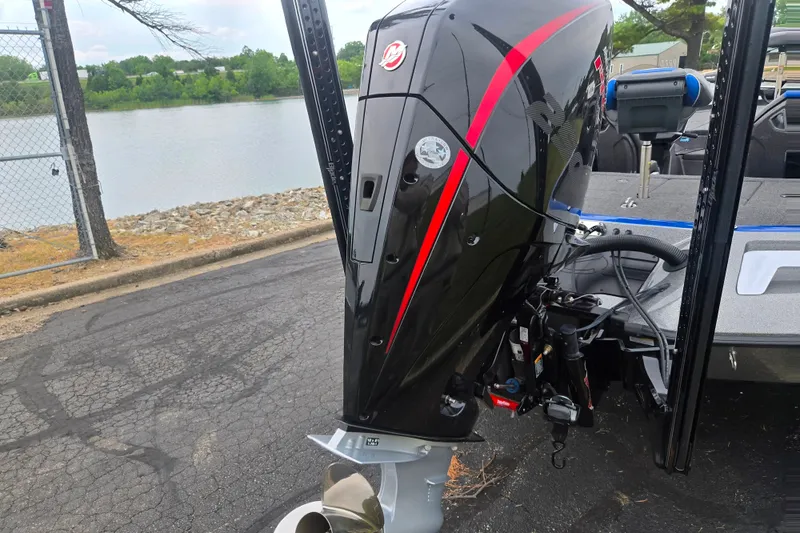 Slide: The Image of 2023 Ranger Z521R boat engine by a lakeside, showcasing sleek design and powerful performance. - 2