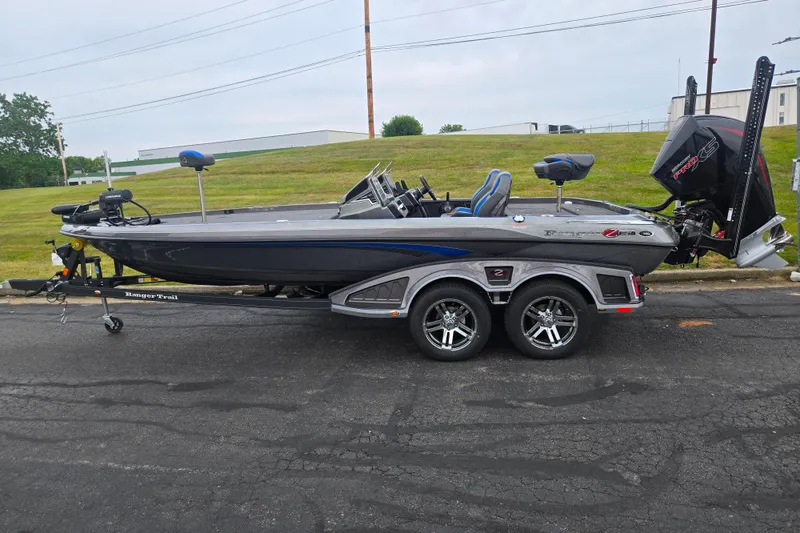 Slide: The Image of 2023 Ranger Z521R fishing boat on trailer, parked outdoors, side view. - 4