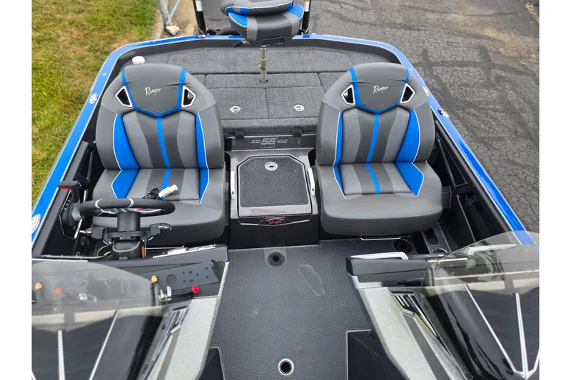 Slide: The Image of 2023 Ranger Z521R boat interior with dual blue and gray seats, steering wheel, and console. - 17