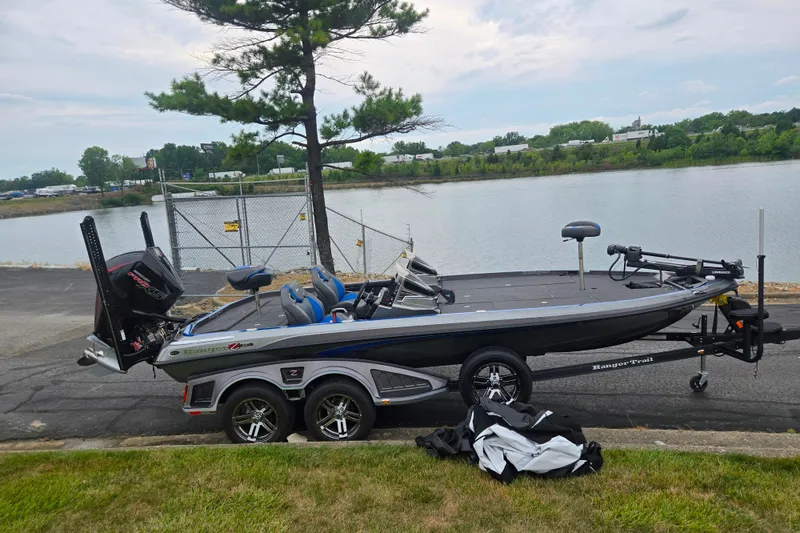 The Image of 2023 Ranger Z521R boat on trailer by a lakeside, ready for fishing adventure. - 0