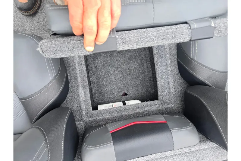 Slide: The Image of 2023 Tracker Pro Team 175 TXW boat storage compartment with gray upholstery and hand lifting seat. - 19