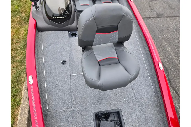 Slide: The Image of 2023 Tracker Pro Team 175 TXW boat with gray seating and red accents on deck. - 16