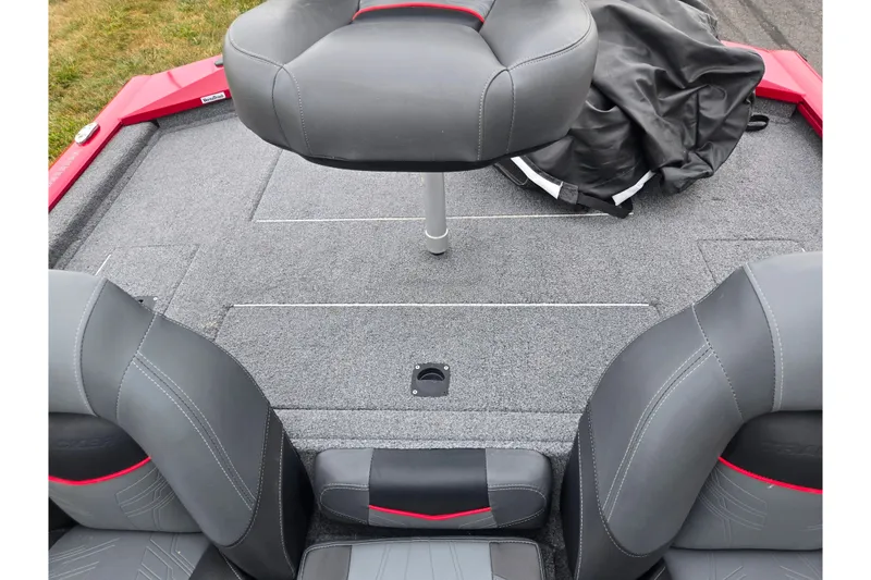 Slide: The Image of 2023 Tracker Pro Team 175 TXW boat interior with gray seating and carpeted deck. - 20