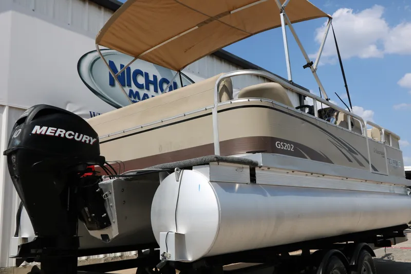 Slide: The Image of 2011 Sun Cruiser GS202 pontoon boat with Mercury engine, displayed outdoors under blue sky. - 5