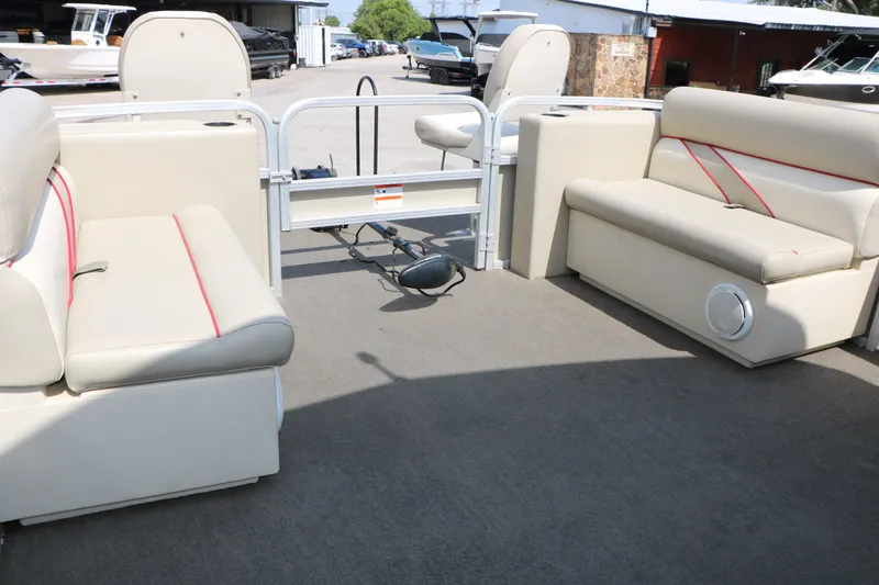 Slide: The Image of Interior of 2011 Sun Cruiser GS202 pontoon boat with beige seating and red accents. - 25