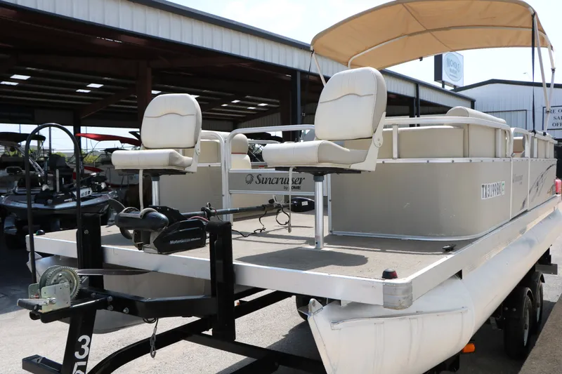 Slide: The Image of 2011 Sun Cruiser GS202 pontoon boat with canopy and trailer in a storage facility. - 6