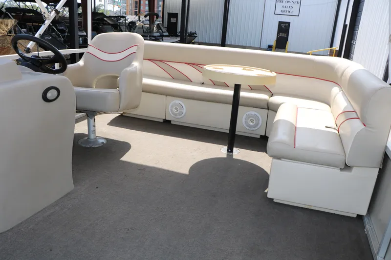 Slide: The Image of Interior of 2011 Sun Cruiser GS202 pontoon boat with beige seating and steering console. - 22