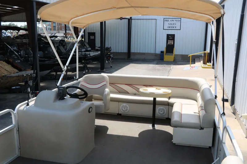 Slide: The Image of 2011 Sun Cruiser GS202 pontoon boat with canopy and seating in a sales lot. - 14