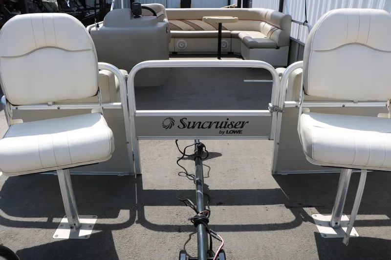 Slide: The Image of 2011 Sun Cruiser GS202 pontoon boat interior with white seating and Suncruiser branding. - 11