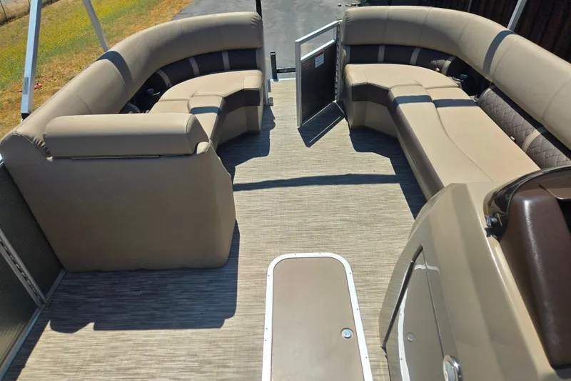 Slide: The Image of 2022 Bennington L24 pontoon boat interior with beige seating and open deck layout. - 20