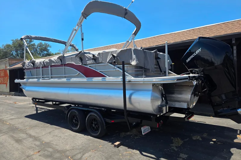 Slide: The Image of 2022 Bennington L24 pontoon boat on trailer with Mercury outboard motor. - 6