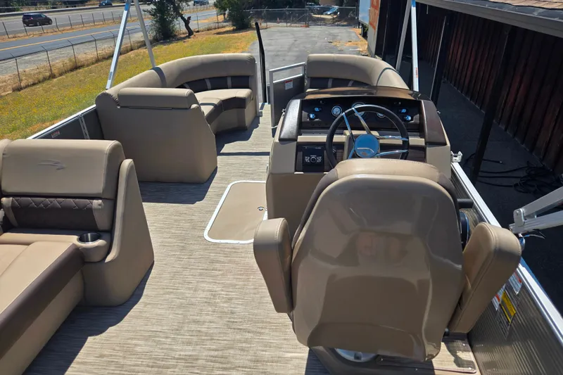 Slide: The Image of 2022 Bennington L24 pontoon boat interior with steering console and seating. - 10