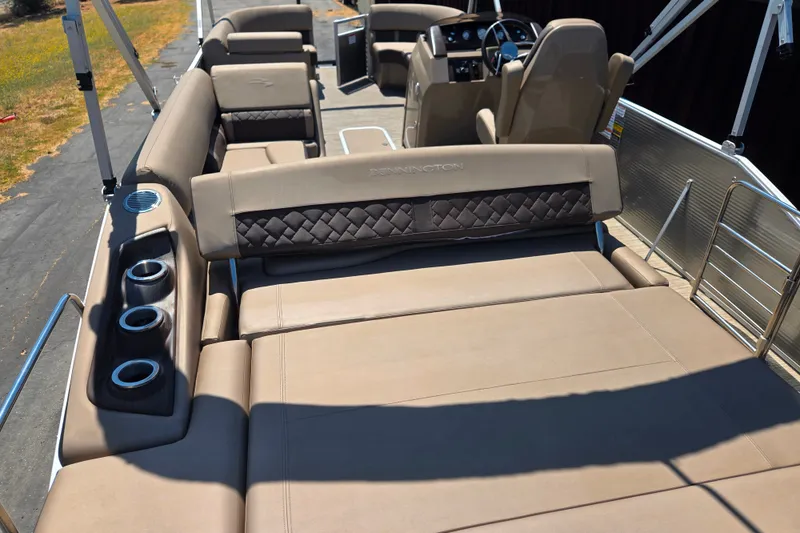 Slide: The Image of 2022 Bennington L24 pontoon boat interior with luxurious seating and cup holders. - 24