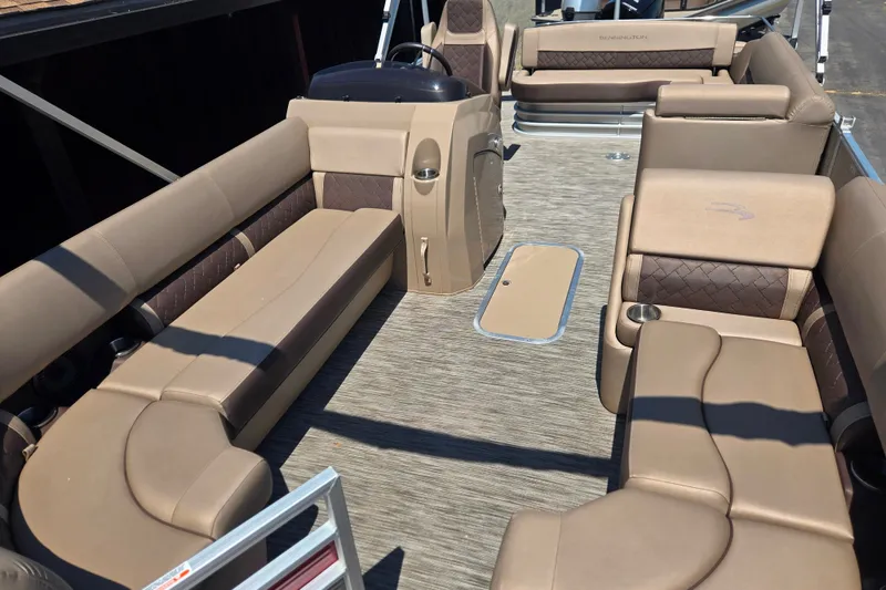 Slide: The Image of 2022 Bennington L24 pontoon boat interior with tan seating and modern design. - 14