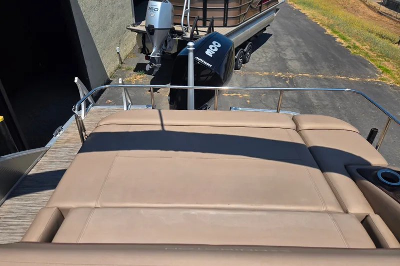 Slide: The Image of 2022 Bennington L24 pontoon boat with Yamaha 150 outboard motor, viewed from rear deck. - 16