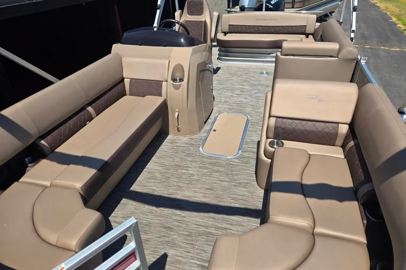 Slide: The Image of 2022 Bennington L24 pontoon boat interior with beige seating and modern design. - 15