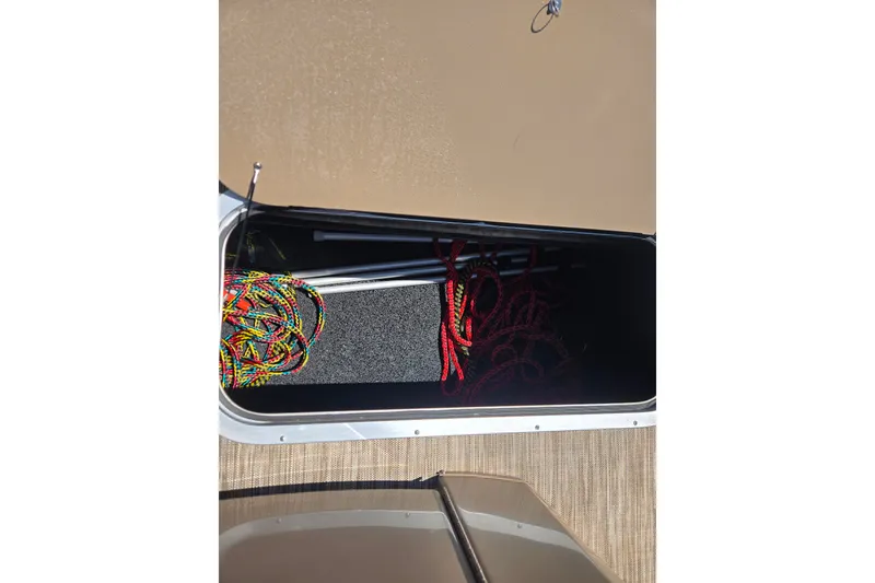Slide: The Image of Storage compartment of 2022 Bennington L24 boat with colorful ropes and equipment. - 25