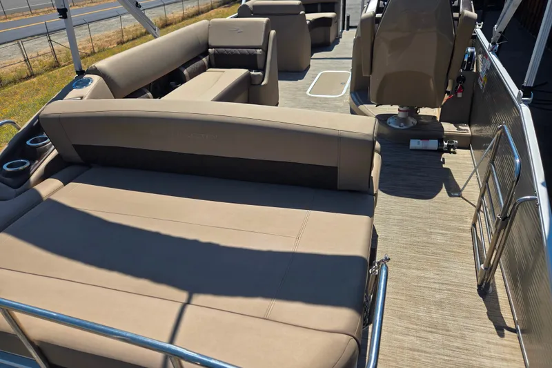Slide: The Image of 2022 Bennington L24 pontoon boat interior with beige seating and cup holders. - 7