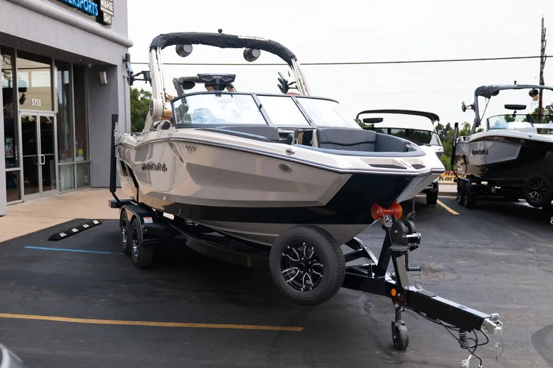 Slide: The Image of 2027 MasterCraft NXT23 boat on trailer outside dealership. - 11
