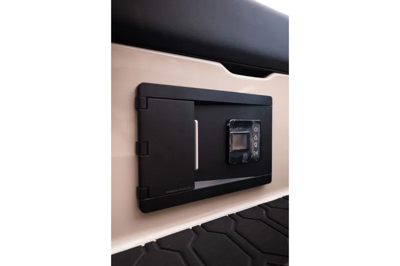 Slide: The Image of Control panel inside 2027 MasterCraft NXT23 boat, featuring sleek black design and digital interface. - 21
