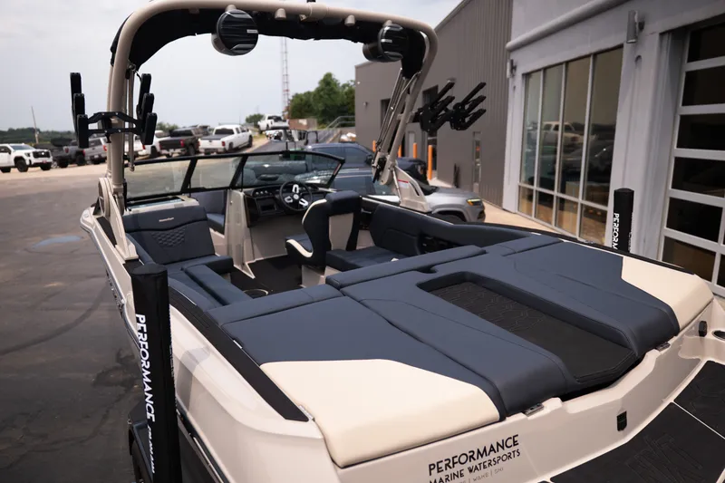 Slide: The Image of 2027 MasterCraft NXT23 boat with sleek interior design at a marina. - 15