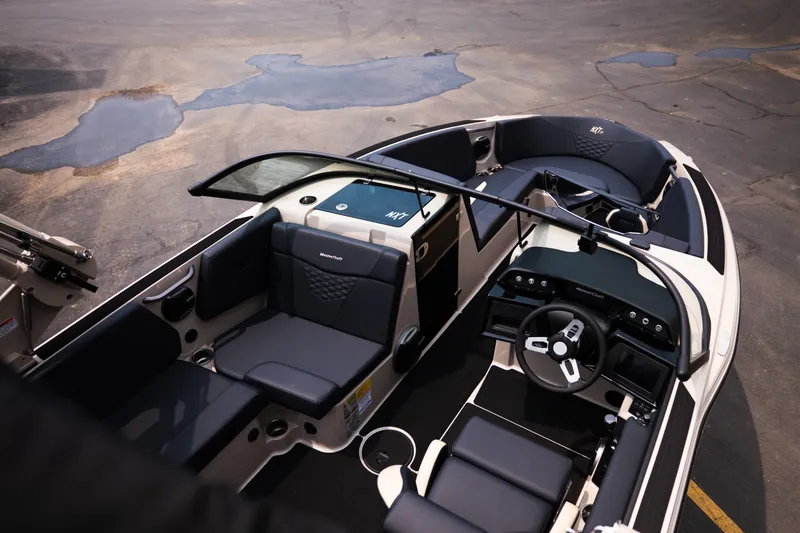 Slide: The Image of 2027 MasterCraft NXT23 boat interior with sleek seating and modern dashboard design. - 17