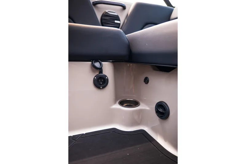 Slide: The Image of Interior detail of 2027 MasterCraft NXT23 boat, featuring seating and cup holder. - 24