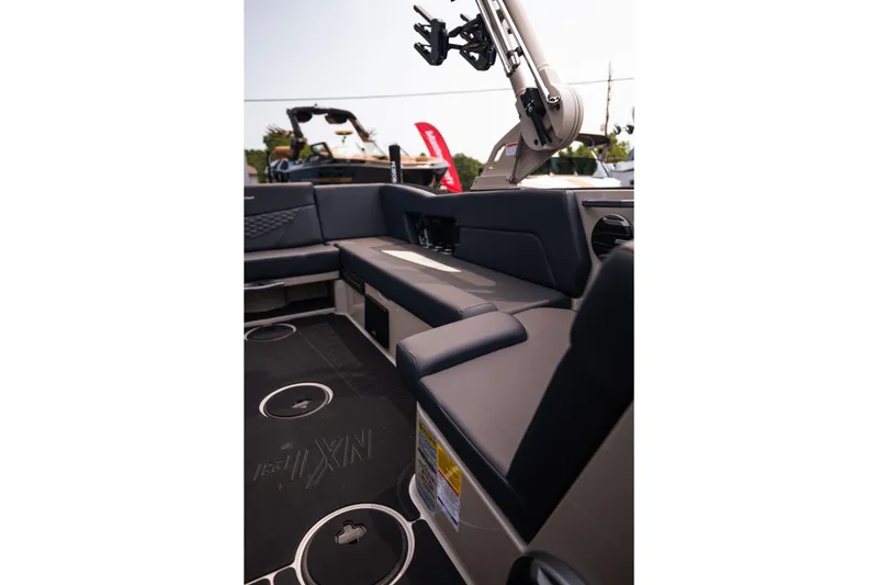 Slide: The Image of 2027 MasterCraft NXT23 boat interior with sleek seating and modern design features. - 29