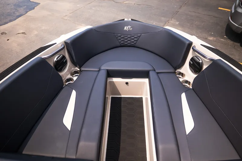 Slide: The Image of Interior view of 2027 MasterCraft NXT23 boat with sleek seating and cup holders. - 25