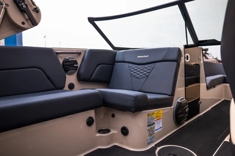 Slide: The Image of 2027 MasterCraft NXT23 boat interior with sleek black seating and modern design. - 23