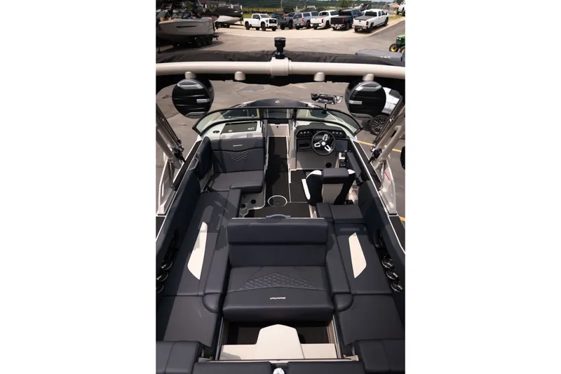 Slide: The Image of 2027 MasterCraft NXT23 boat interior with sleek black seating and modern dashboard design. - 20