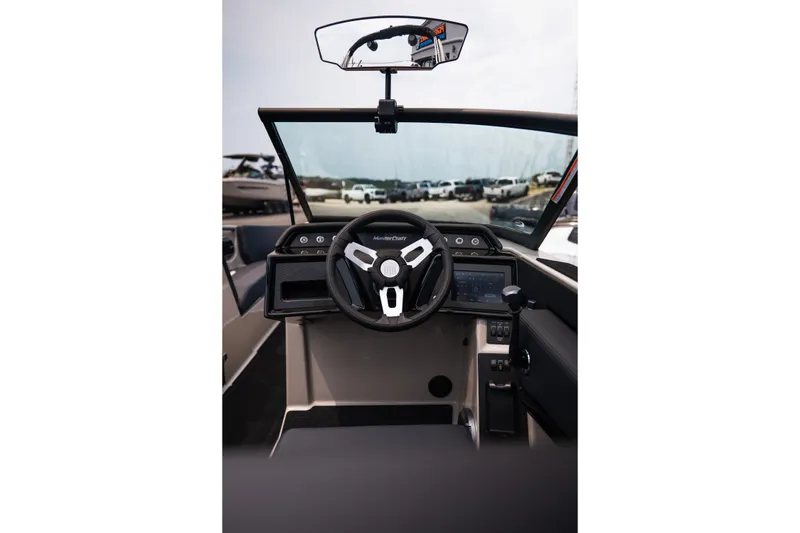 Slide: The Image of Interior view of 2027 MasterCraft NXT23 boat cockpit with steering wheel and dashboard controls. - 31
