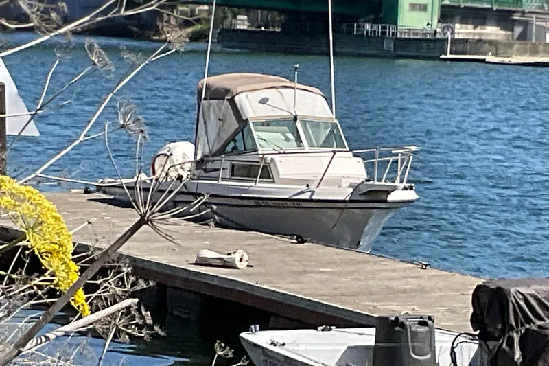 The Image of 1991 Grady-White Overnighter 204 boat docked on a sunny waterfront. - 2