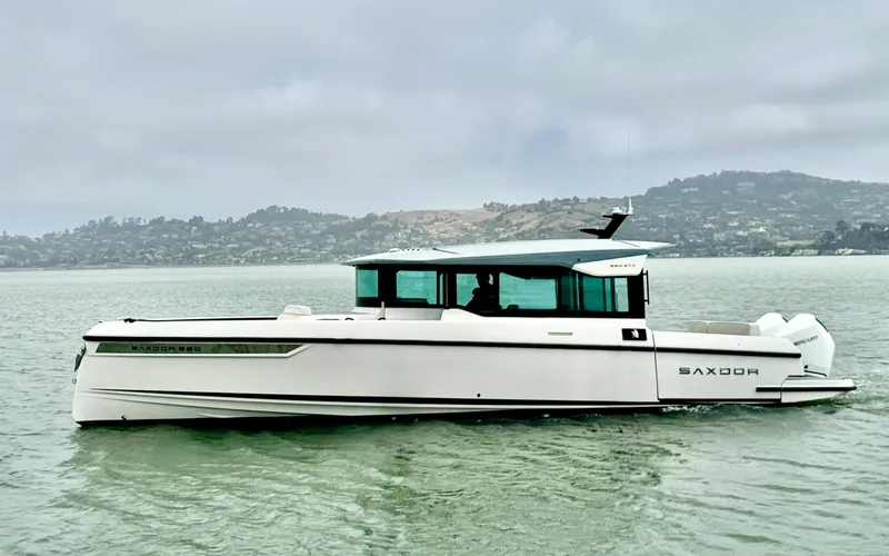 The Image of A 2025 Saxdor 320 GTC cruising on calm waters with a cloudy sky in the background. - 0