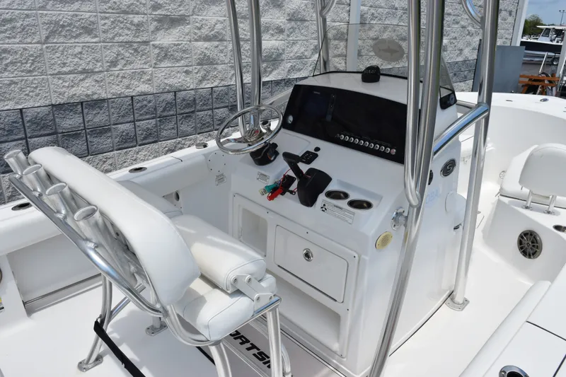 Slide: The Image of 2015 Sportsman Open 212 Center Console boat interior with steering wheel and seating. - 5