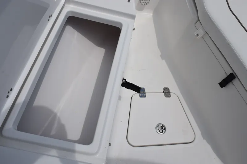 Slide: The Image of 2015 Sportsman Open 212 Center Console storage compartment and hatch detail. - 11