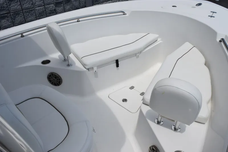 Slide: The Image of 2015 Sportsman Open 212 Center Console boat interior with white cushioned seating. - 7