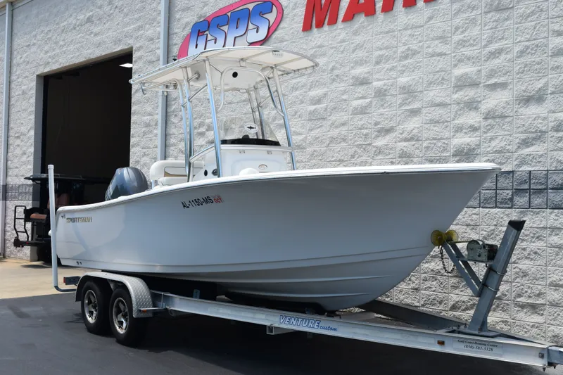 Slide: The Image of 2015 Sportsman Open 212 Center Console boat on trailer outside dealership. - 2