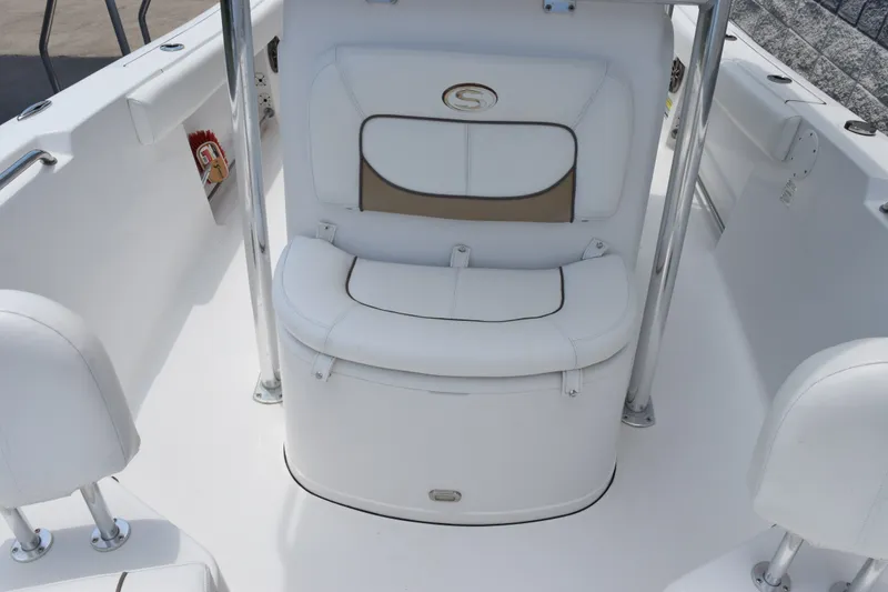Slide: The Image of 2015 Sportsman Open 212 Center Console boat interior with white seating and storage. - 8