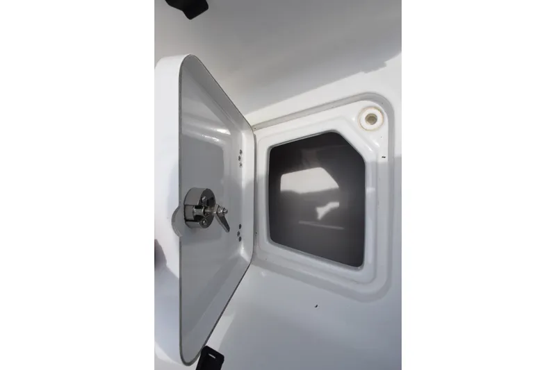 Slide: The Image of Open storage compartment on a 2015 Sportsman Open 212 Center Console boat. - 12