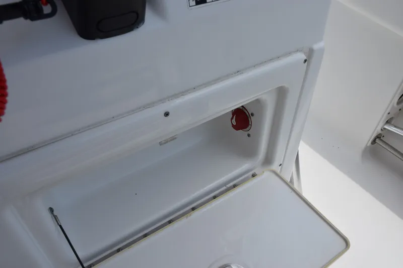 Slide: The Image of 2015 Sportsman Open 212 Center Console storage compartment with open hatch. - 10