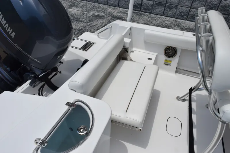 Slide: The Image of 2015 Sportsman Open 212 Center Console boat interior with seating and Yamaha engine. - 6