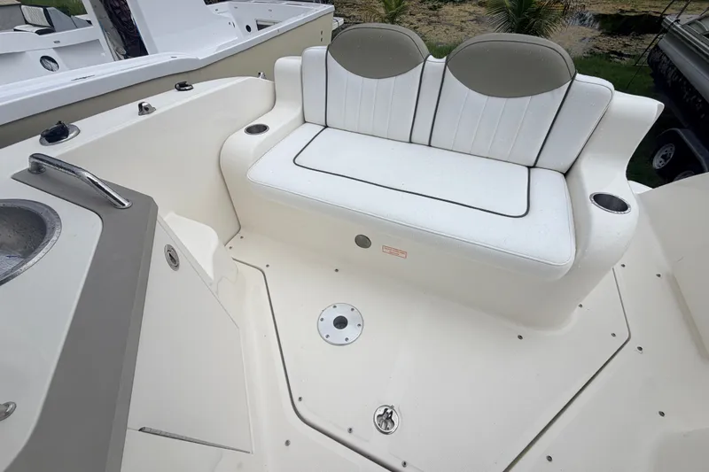 Slide: The Image of 2007 Sea Ray 240 Sundancer boat interior with white seating and cup holders. - 21