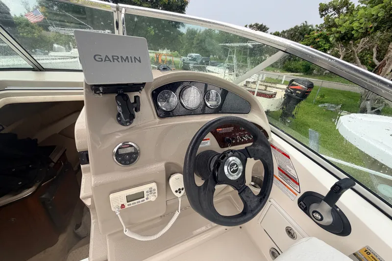 Slide: The Image of 2007 Sea Ray 240 Sundancer helm with Garmin GPS and steering wheel. - 17