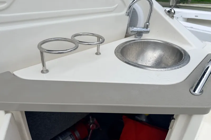Slide: The Image of 2007 Sea Ray 240 Sundancer boat sink and cup holders in cockpit area. - 20