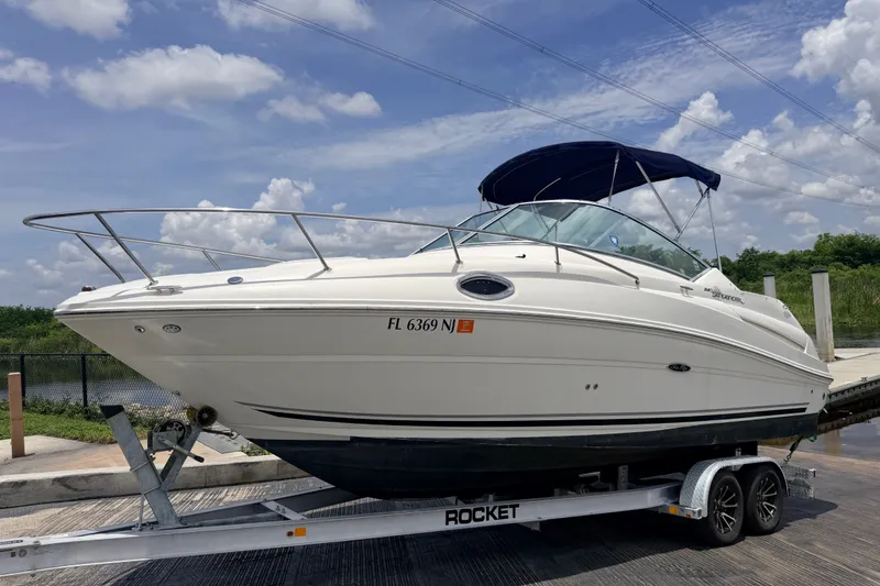 Slide: The Image of 2007 Sea Ray 240 Sundancer boat on trailer under blue sky. - 0