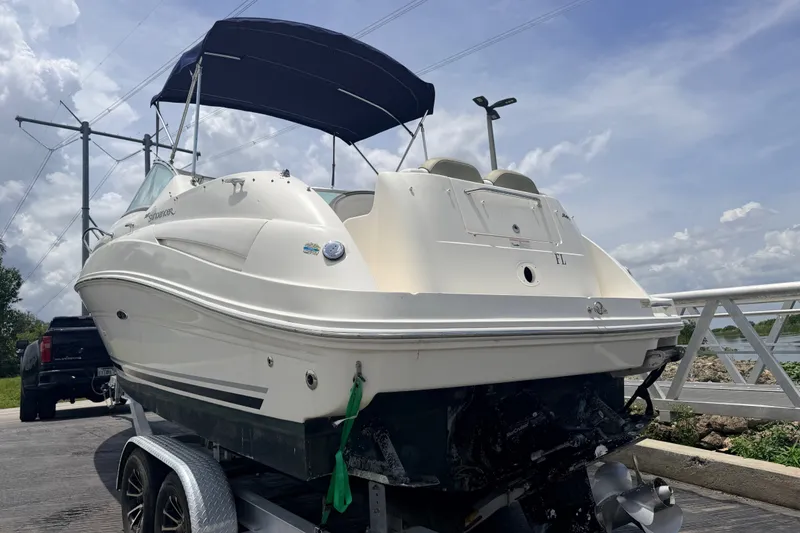 Slide: The Image of 2007 Sea Ray 240 Sundancer boat on trailer, under blue sky, ready for launch. - 2