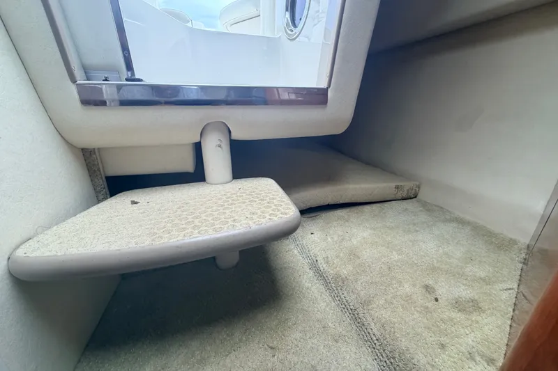 Slide: The Image of Interior cabin view of a 2007 Sea Ray 240 Sundancer boat, featuring carpeted flooring. - 25