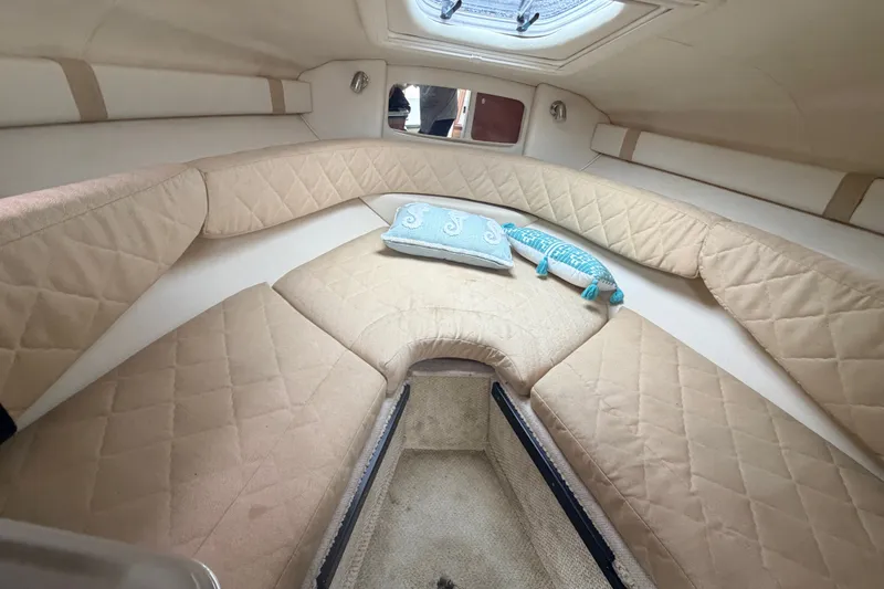 Slide: The Image of Interior cabin of 2007 Sea Ray 240 Sundancer with beige upholstery and decorative pillows. - 23